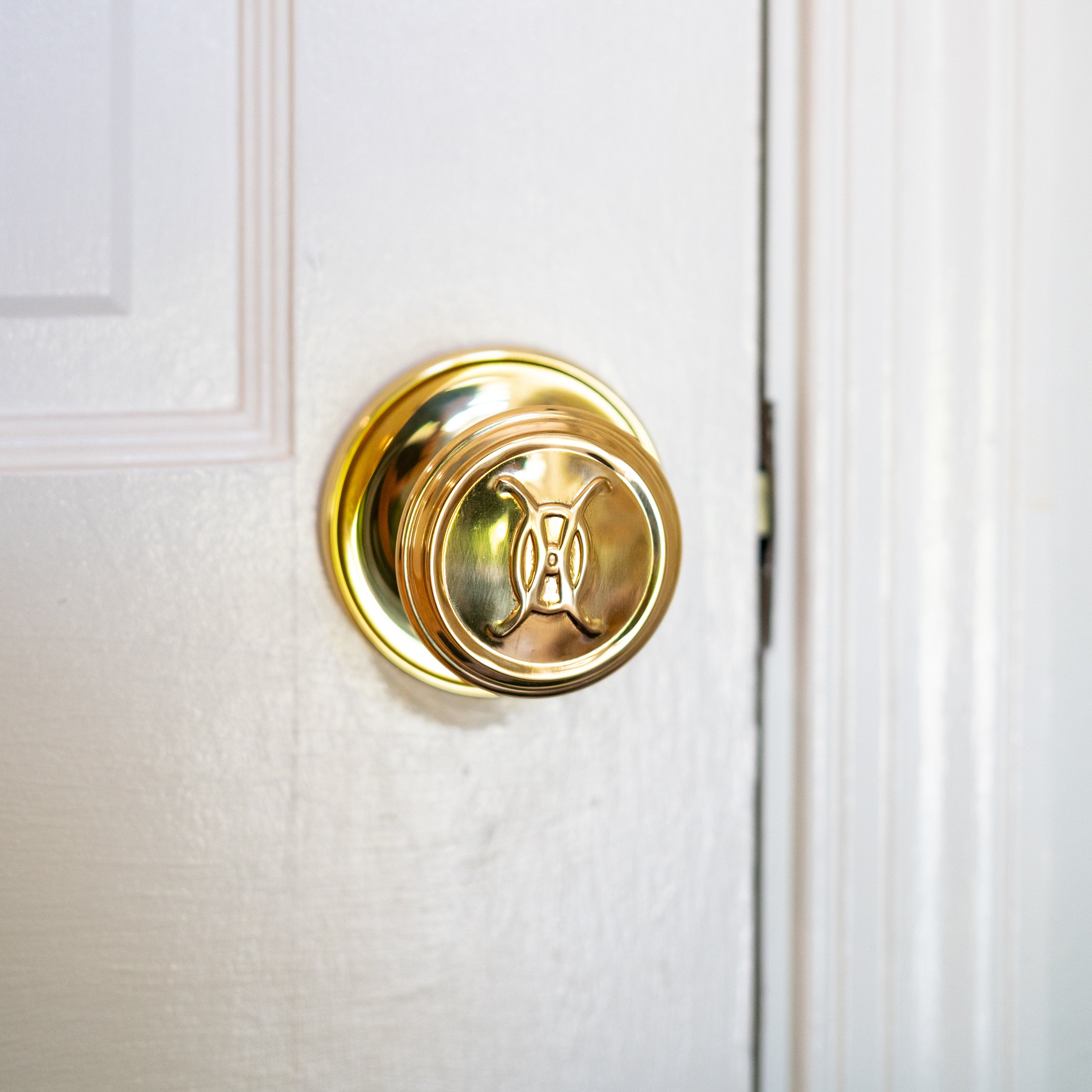 Valencia Logo Passage Door Knob Set - Polished Brass