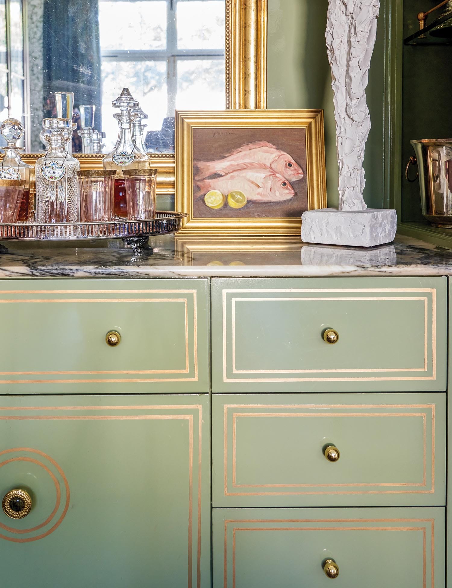 Clementine Knobs by Mark D. Sikes and Venezia Custom Knobs by Michelle Nussbaumer perfectly complement the gold painted details on the Baton Rouge Showhouse living room's wet bar, designed by Ashley Gilbreath. Photo by Paul Costello