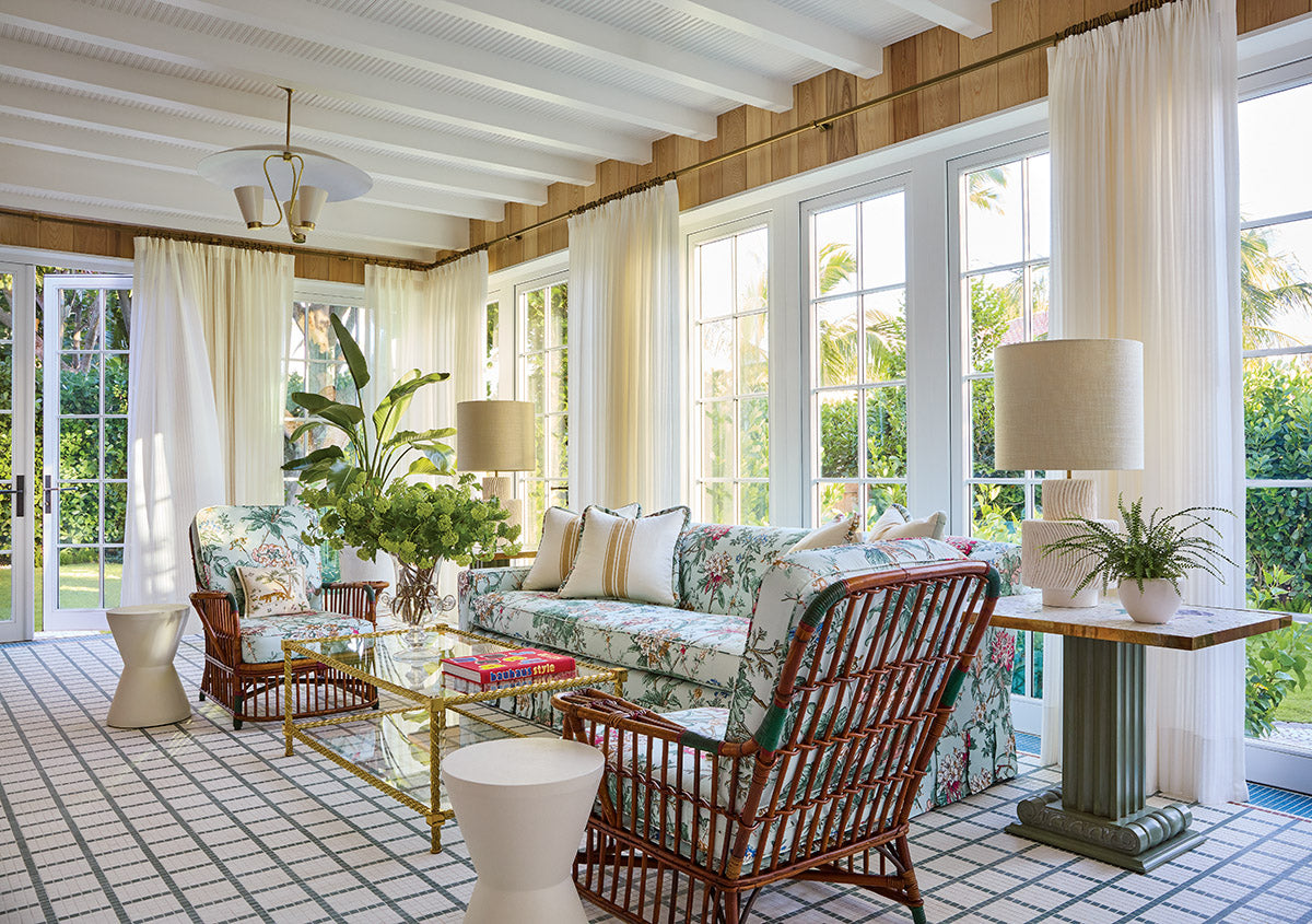 Sunlight floods the Florida Room, where a custom tile floor by American Restoration Tile turns the entire space into a patterned canvas.