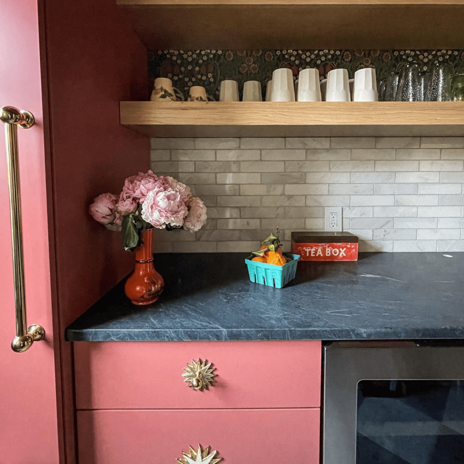 Blending slab cabinetry and brass hardware