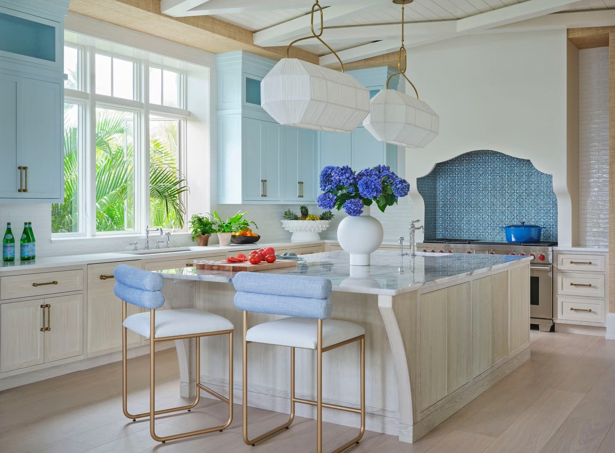 Cabinet hardware: Cosmos Pulls, Cabinet paint: Harbor Fog, Benjamin Moore. Range: Wolf. Range backsplash: Casa Ceramica. Pendants: Visual Comfort & Co.