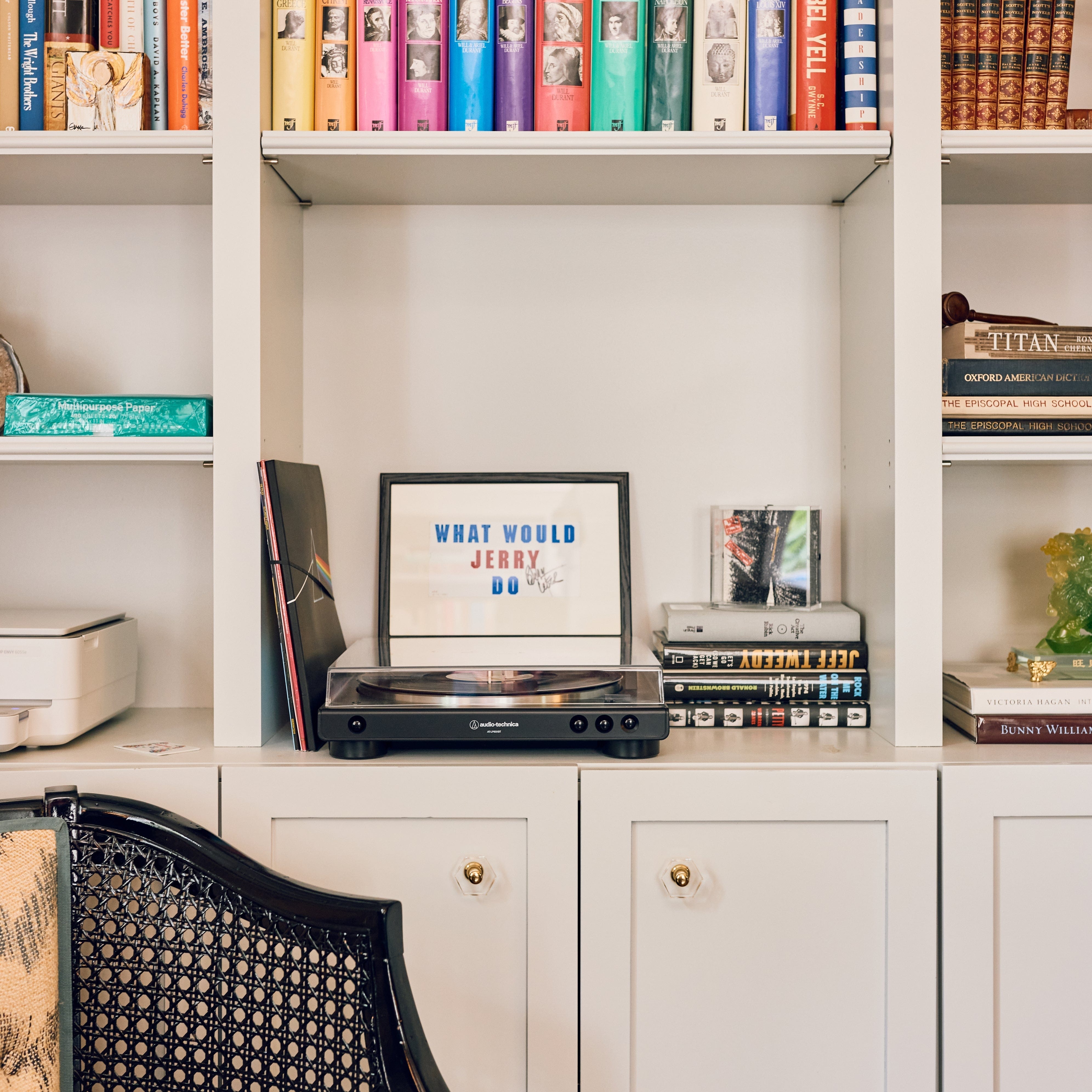 Record player on a shelf with books and decor