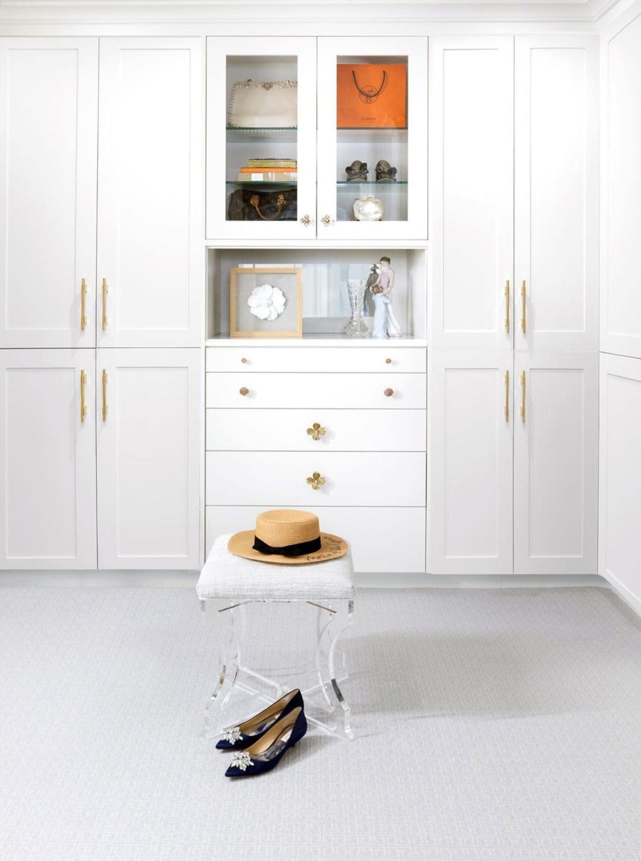 Clean White Closet with Built In Drawers Featuring Dogwood Knobs